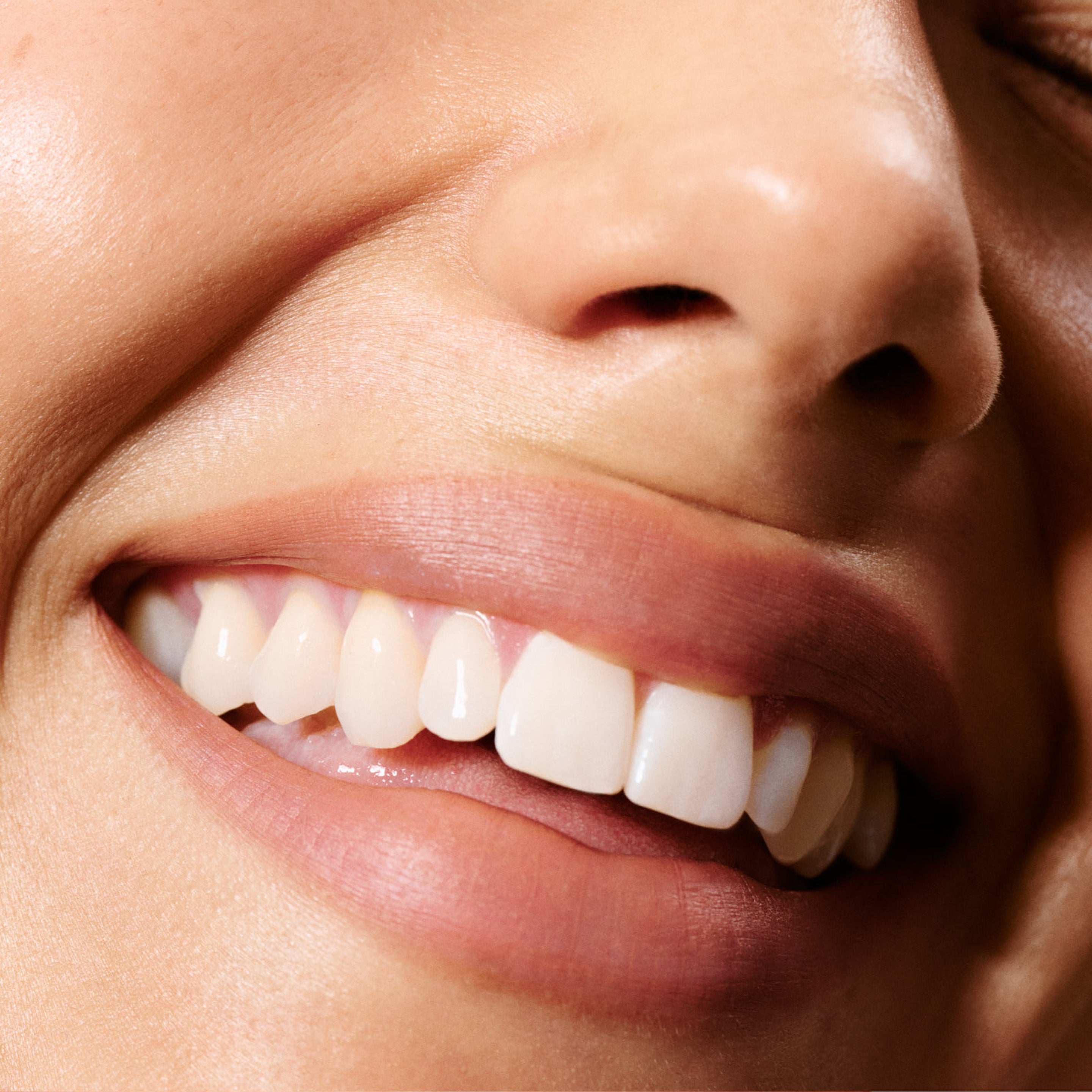 Close-up of a person's mouth with a focus on golden medium nude lip liner.