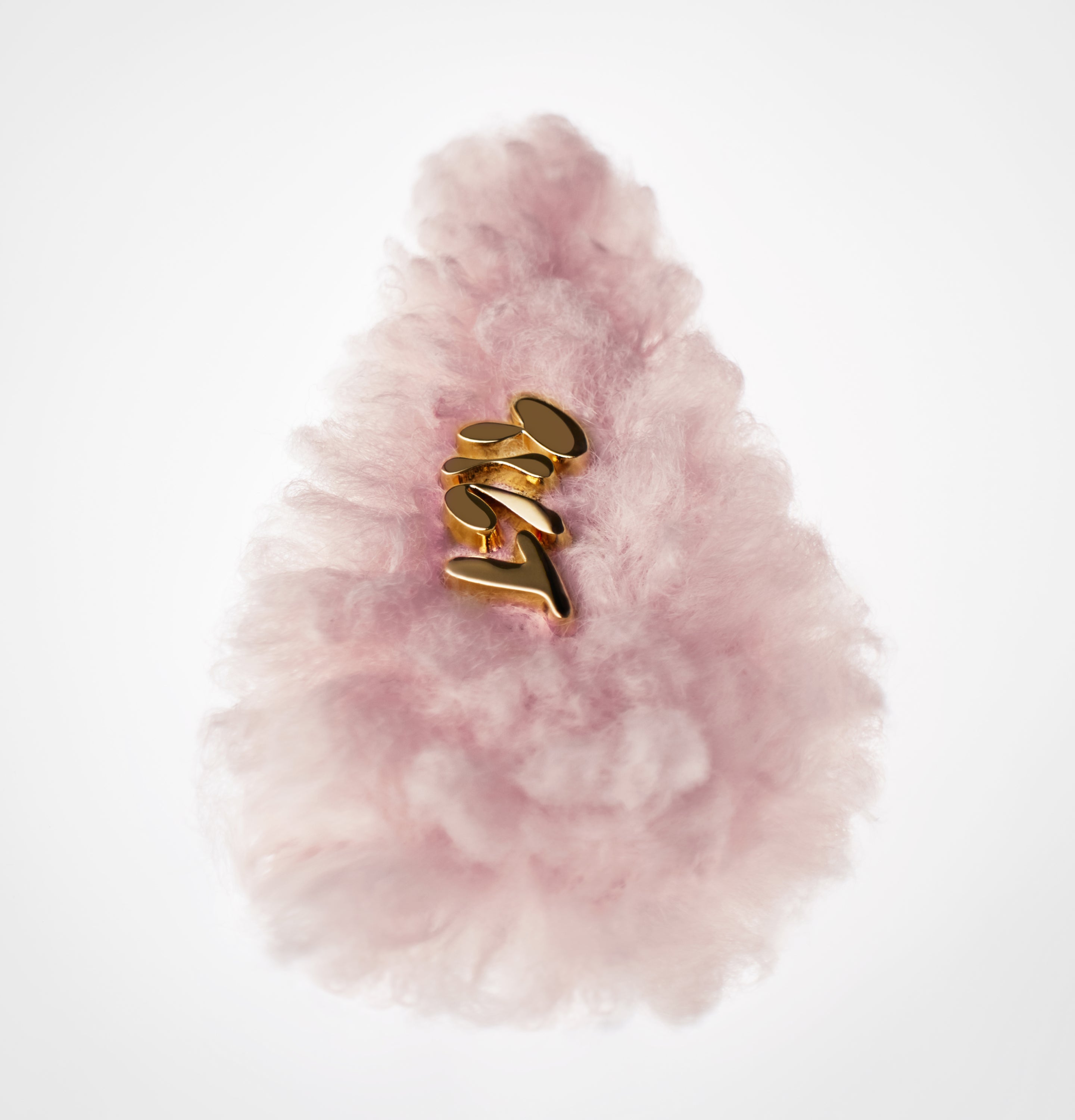 Pink fluffy hair clip with 'Tilt' in gold on a white background.