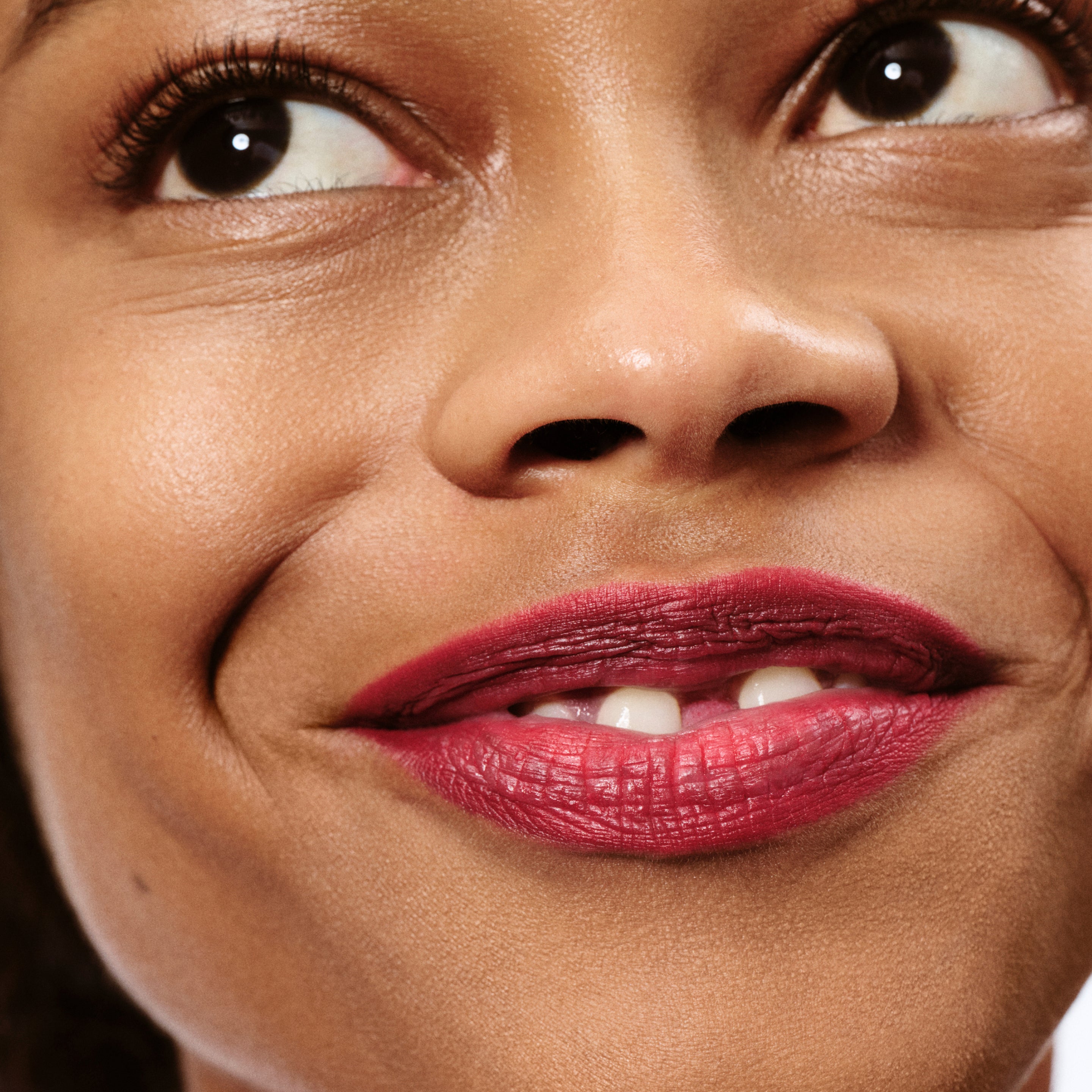 Close-up of a woman's face with a focus on her lips, wearing lip liner in a universal true red