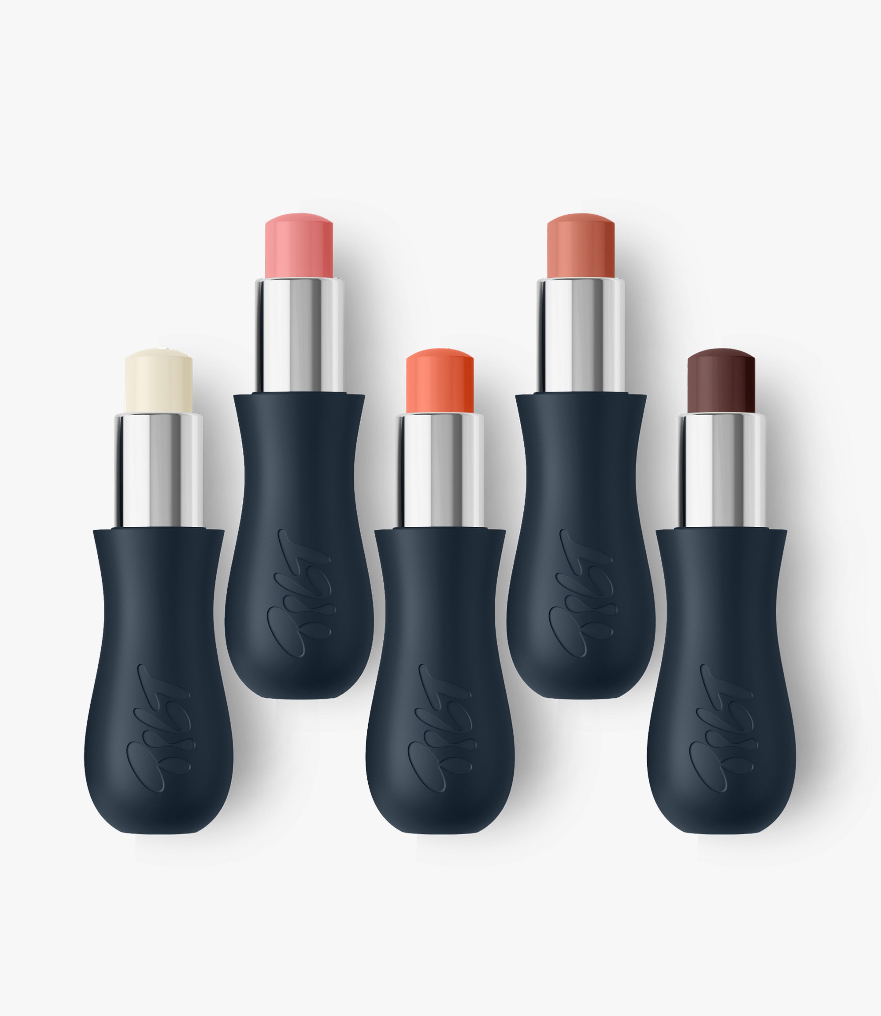 All five Gripstick Lip Treatments together. Sheer nude, sheer coral, sheer berry, clear and baby pink each in their inky curvy cases.