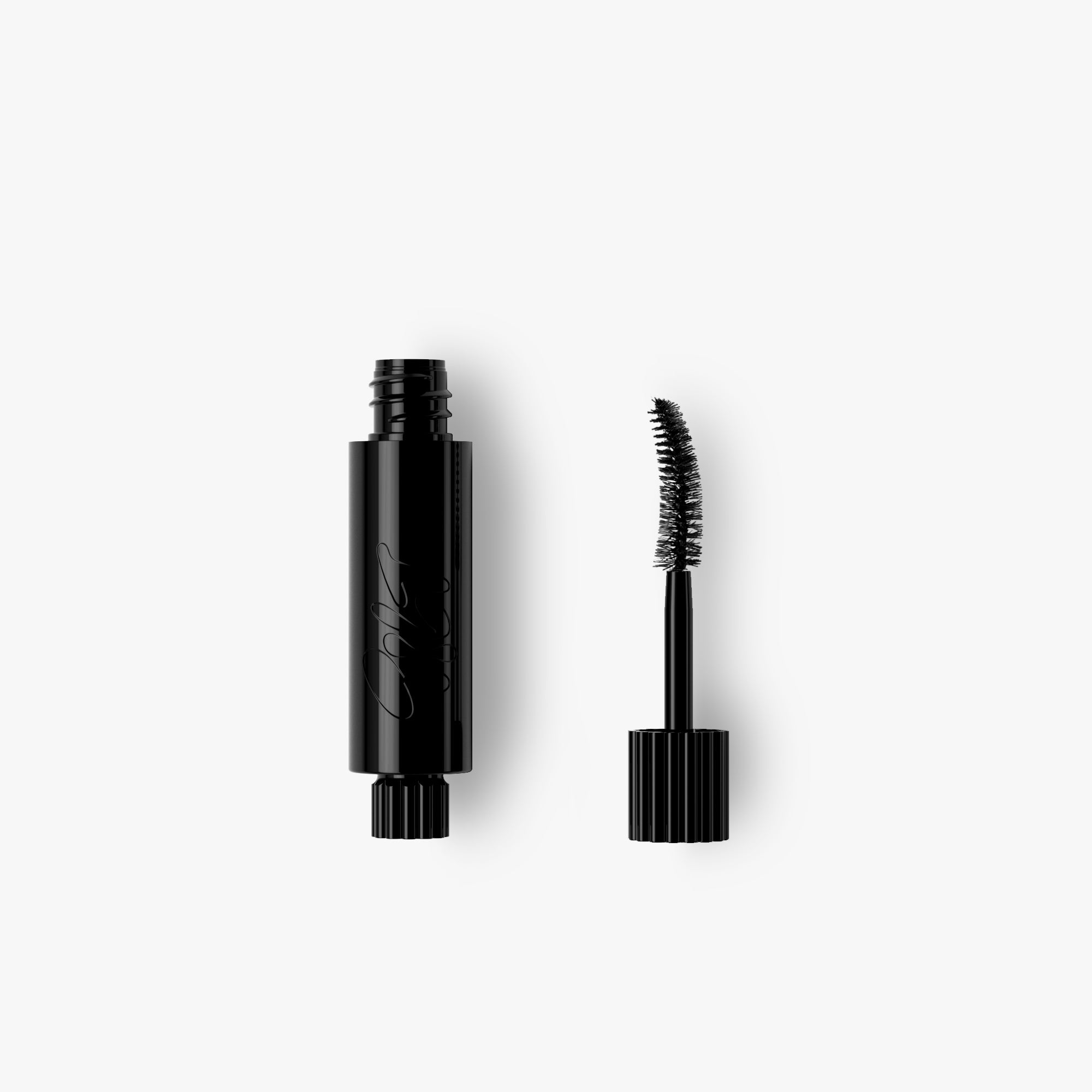 Black refill tube of mascara with another new brush